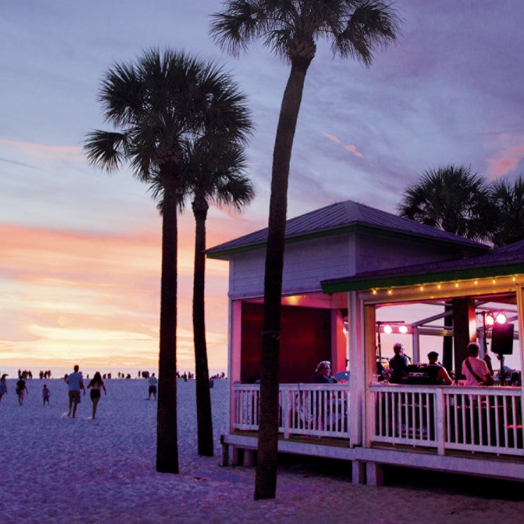 After Sunset view of the beach and a beach bar with palm trees on the beach with a beautiful colorful sky