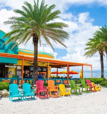 Colorful Adirondack chairs on the beach outside of Frenchy's Rockaway Grill