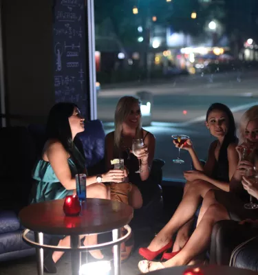 A group of woman talk over cocktails at a bar in downtown St. Pete