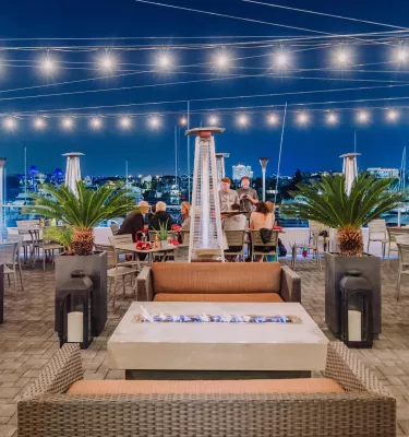 Image of outside dining area at Marina Cantina restaurant in Clearwater, FL. Featuring string lights and cushy seating for comfortable al-fresco dining.
