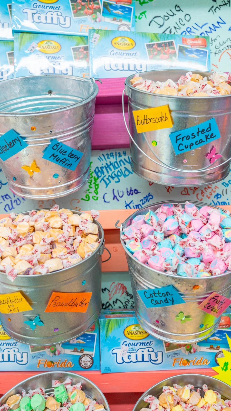metal buckets holding colorful pieces of different candies