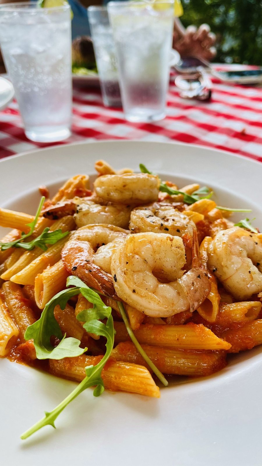 shrimp on top of pasta in white bowl