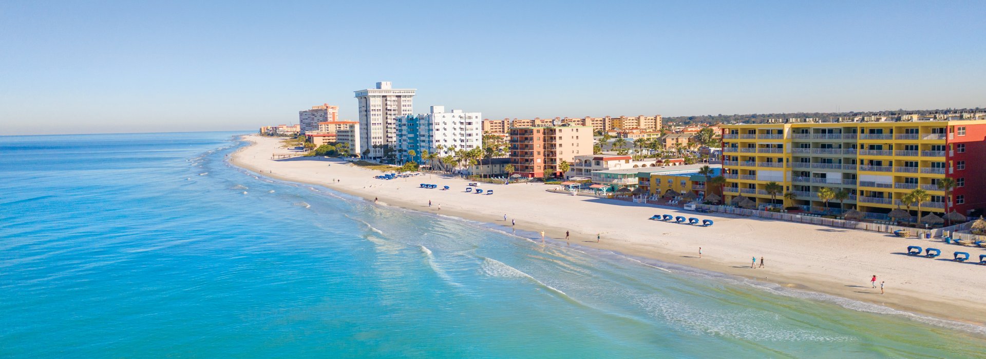 Aerial view of North Redington Beach with calm, blue-green Gulf waters to the west and condos to the east