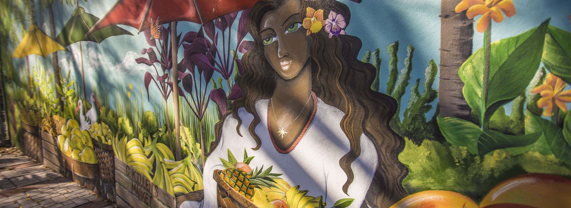 A mural of a lady holding a fruit basket from the Florida Botanical Gardens