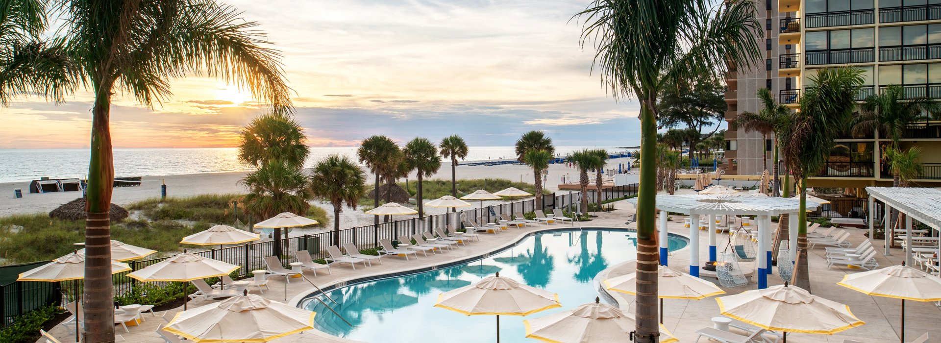 The pool at Sirata Resort with a view of St. Pete Beach horizon during sunset