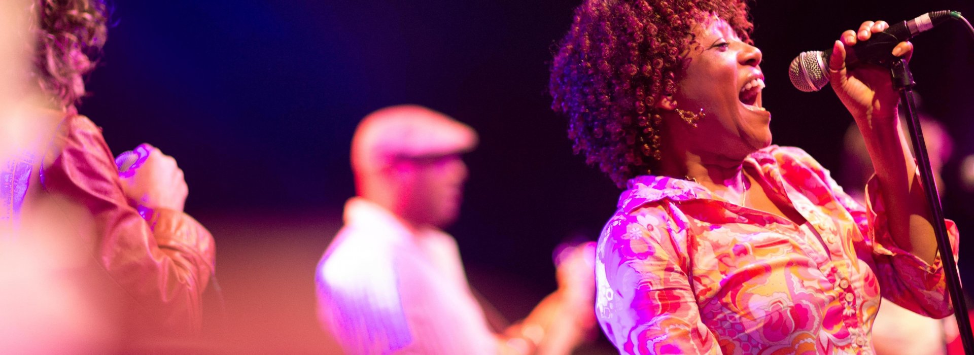 An African-American woman singing at Jannus Live in St. Pete.