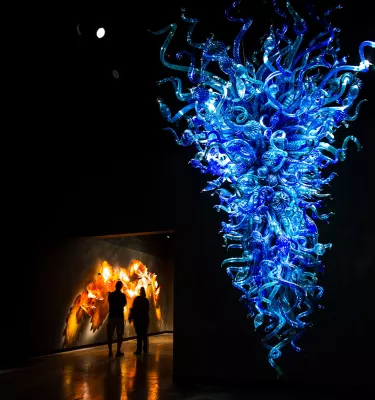 A dramatic deep-blue glass sculpture hanging from the ceiling at the Chihuly Collection in St. Pete
