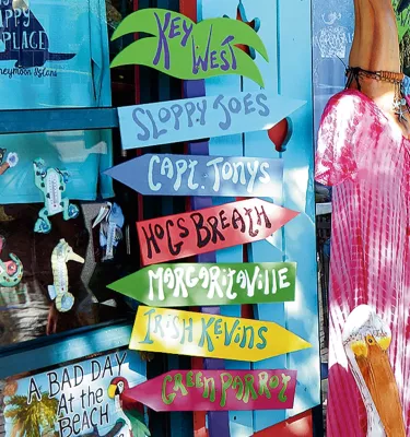 brightly signage decorates a shop window on Main Street in Dunedin, Florida