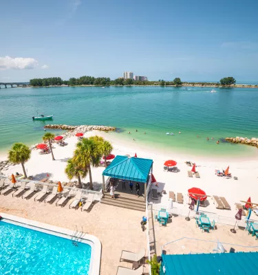 An overview of pool and beachfront of Dolphin Beach Club.