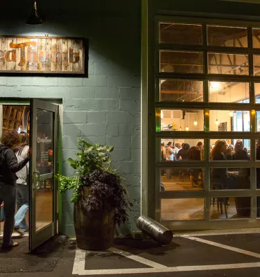 A man entering the Crooked Thumb Brewery in Safety Harbor at night