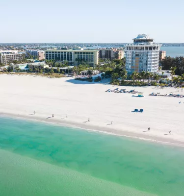 Aerial view of St. Pete Beach emerald-green waters with Bellwether Beach Resort in the background
