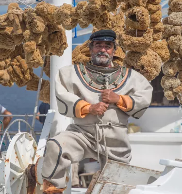 A sponge diver in a boat with lots of sponges in Tarpon Springs.