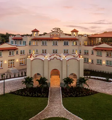 An aerial view of a large hotel at sunrise