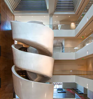 A tightly wound spiral staircase painted white on the exterior.