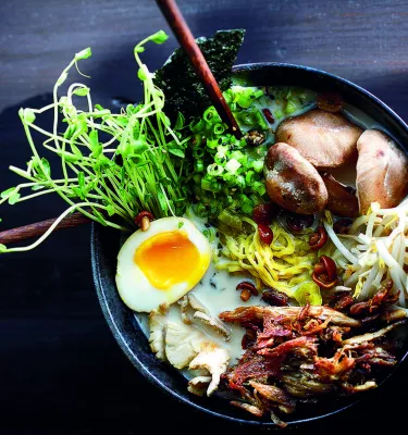 A delicious looking bowl of ramen with crispy duck, half a hard boiled egg, greens and mushrooms at Buya Ramen in St. Pete