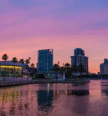 A vibrant pink and purple sunset over the Saint Pete Waterfront District.