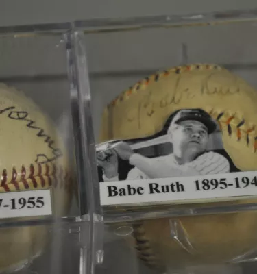 a glass case containing a baseball signed by Babe Ruth as well as his photo at the St. Petersburg Museum of History