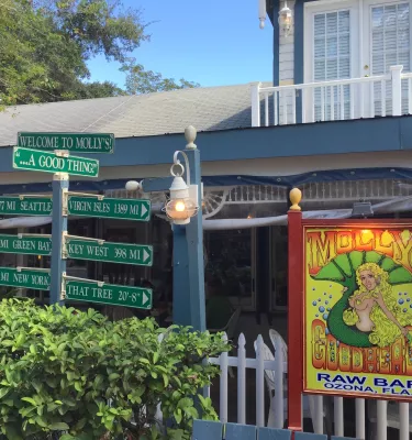 a sign of a mermaid outside Molly Goodheads restaurant in Ozona