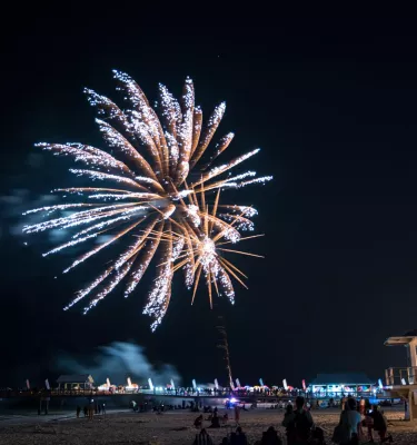 Fireworks explode over the water off Clearwater Beach.