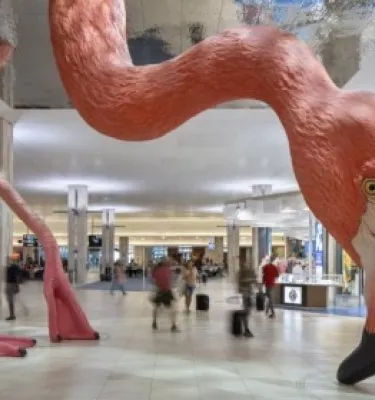 an enormous pink flamingo sculpture with beak to the floor at Tampa International Airport