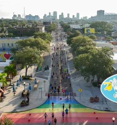 St. Pete Run Fest poster featuring an aerial view of people running through the streets of downtown St. Pete.