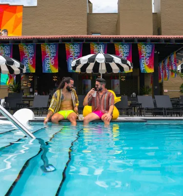 two men sitting on the edge of the pool at The Wet Spot next to the Mari Jean Hotel in St. Pete