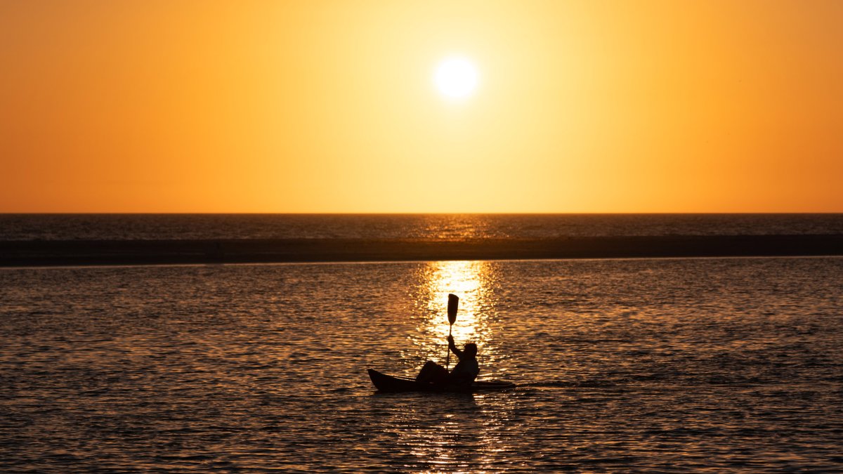A kayaker paddling the waters of Fort de Soto at sunset