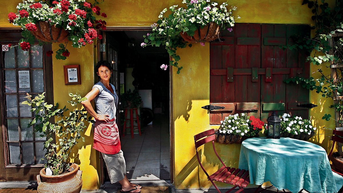 A waitress stands in the doorway of Pia's Trattoria in Gulfport