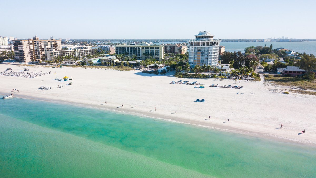 Aerial view of St. Pete Beach emerald-green waters with Bellwether Beach Resort in the background