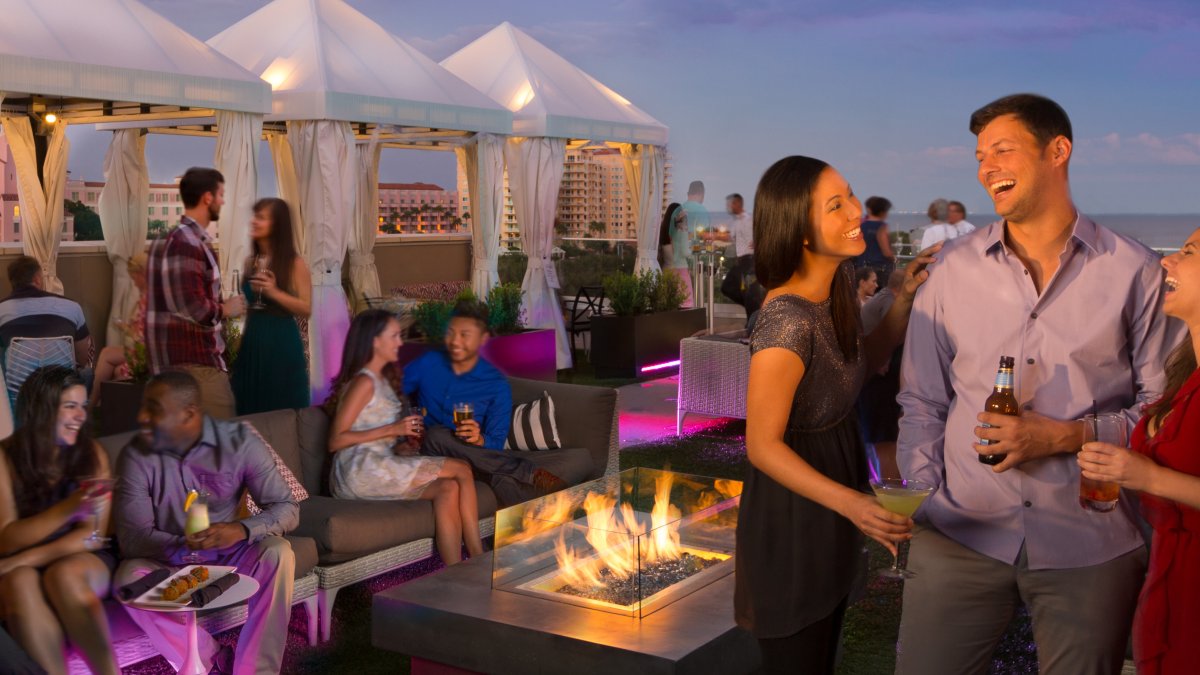 Several people enjoying drinks at The Canopy rooftop in St. Pete