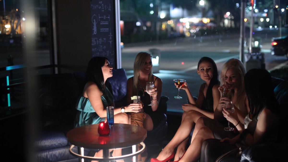 A group of woman talk over cocktails at a bar in downtown St. Pete