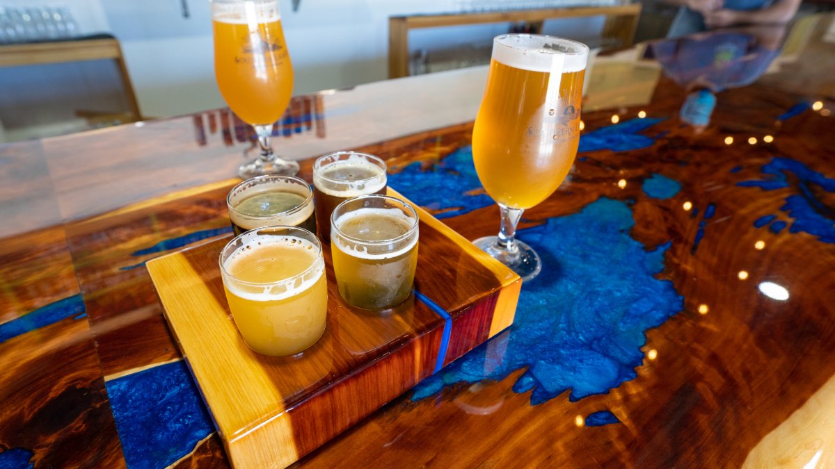 Couple of beer samples on top of a wooden table.