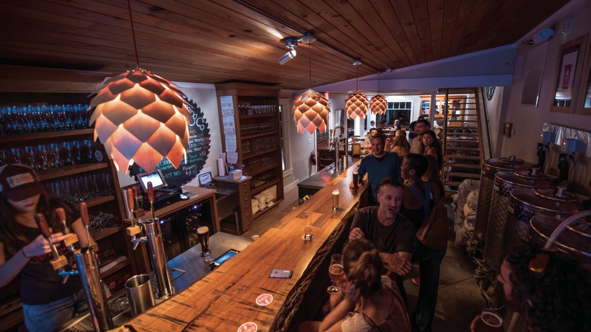Several people enjoying beer at the Woodwright Brewing.