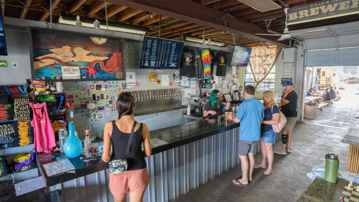 Few people ordering drinks inside Cage Brewing.