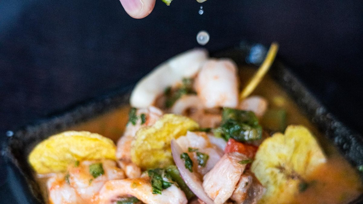 a tight shot of lime squeezed over ceviche