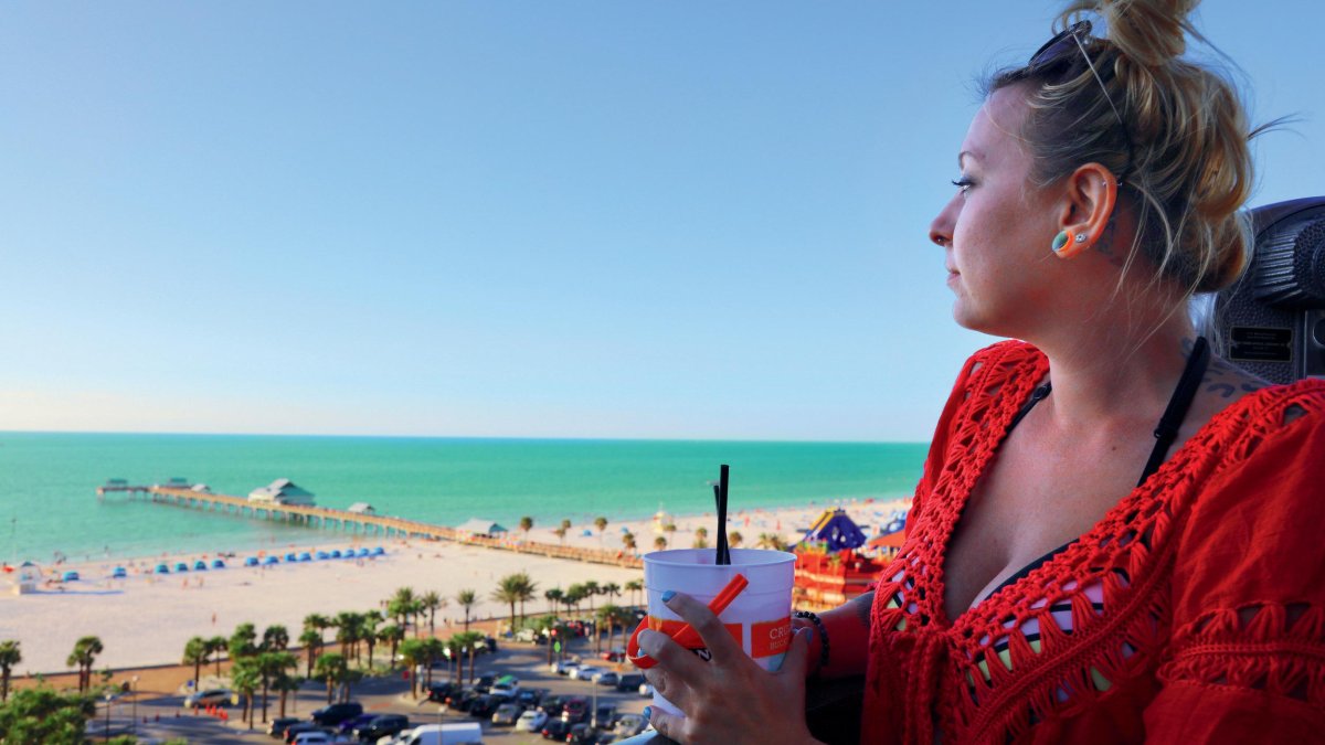 A woman looks out to the beach at Jimmy's Crow's Nest on Clearwater Beach