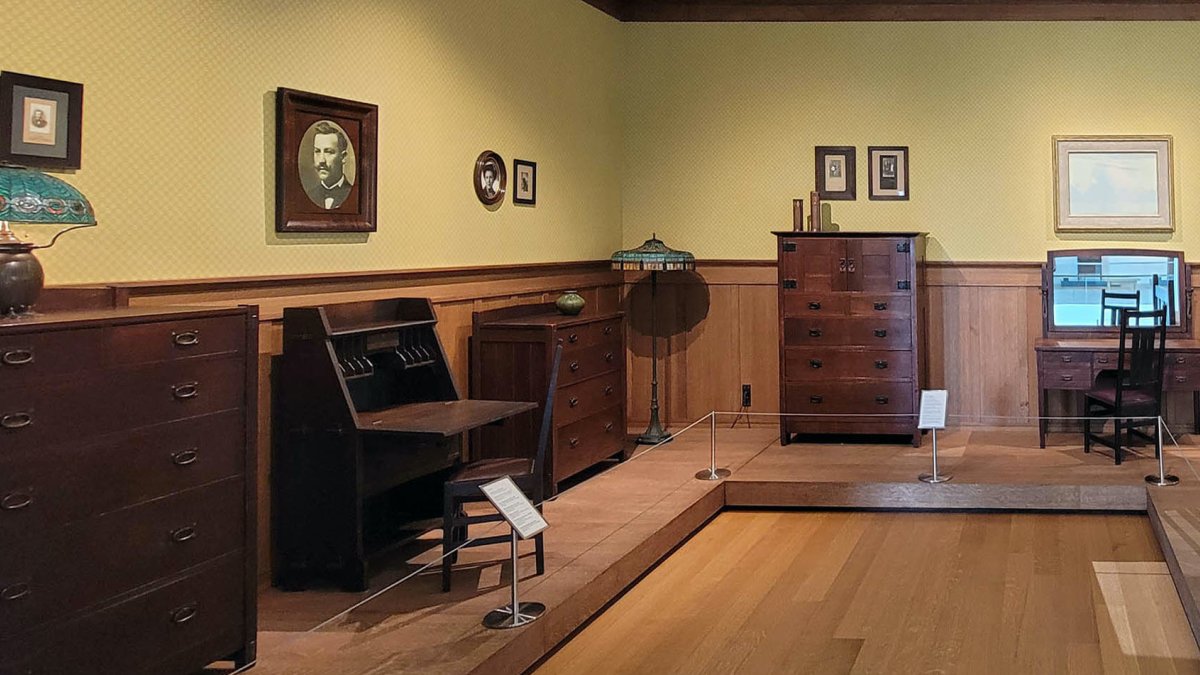 A bedroom decorated with furniture and art from the Arts & Crafts Movement.