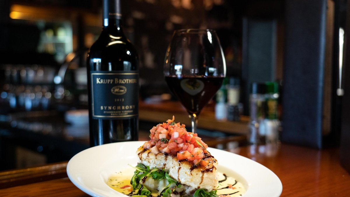 A plated dish and red wine pairing at 1200 Chophouse on St. Pete Beach