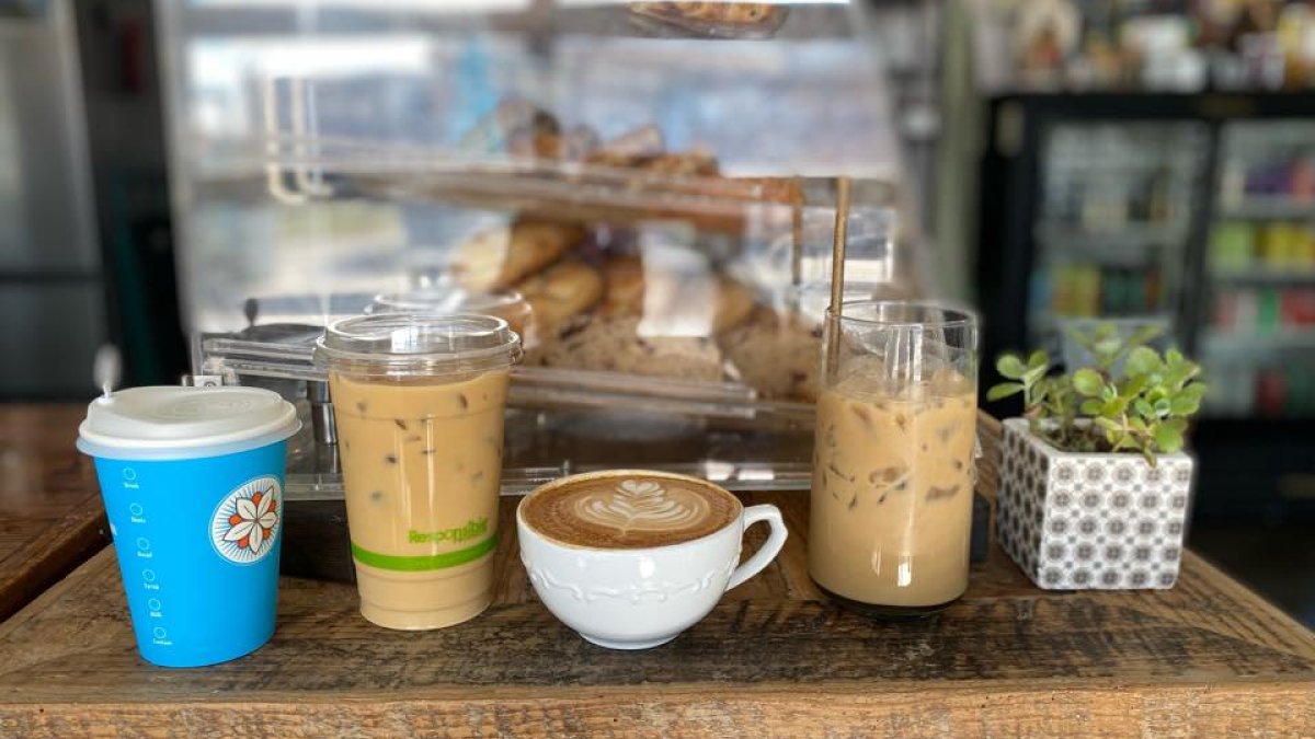 a variety of cold and hot drinks including a cappucino on the counter at The Chelsea St. Pete Coffee Shop