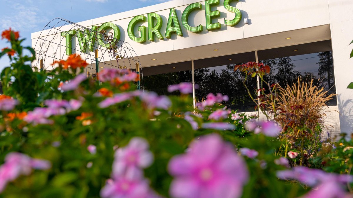 Outside view of Two Graces restaurant in St. Pete with pink flowers in front