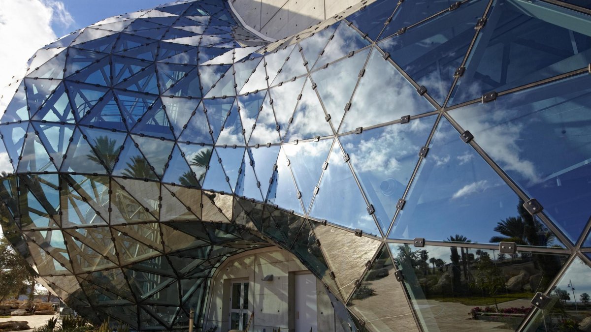 the exterior of the Dali Museum's geodesic dome reflects the clouds and sky