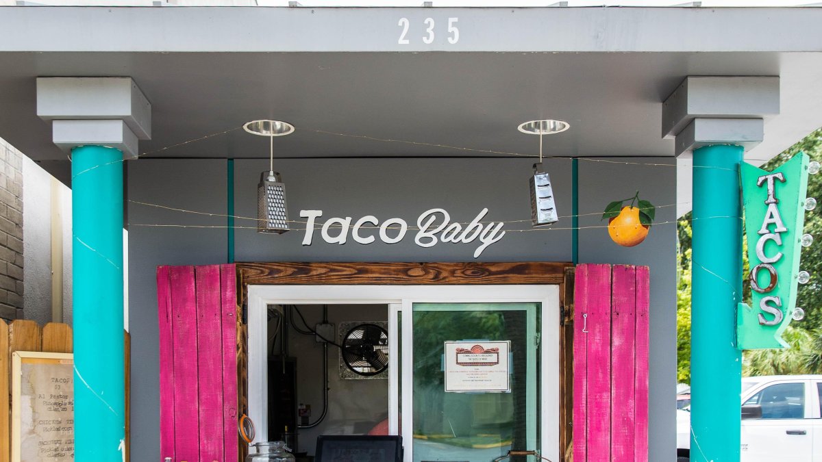 Image of Taco Baby stand outside in Dunedin, FL. Decor includes bold pink and blue colors.