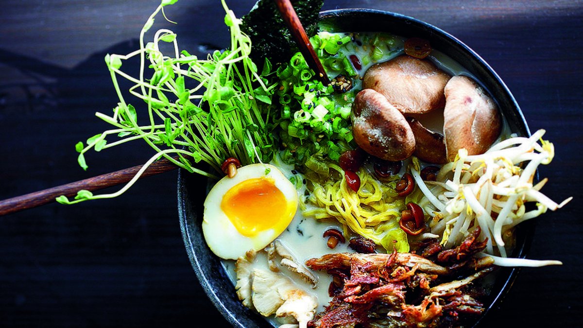 A delicious looking bowl of ramen with crispy duck, half a hard boiled egg, greens and mushrooms at Buya Ramen in St. Pete