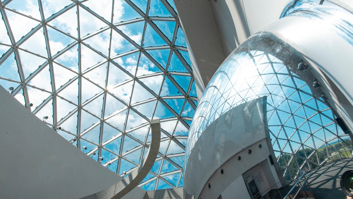 blue key and clouds seen through the curved windows of the "enigma" which is part of the Dali Museum in St. Pete Florida