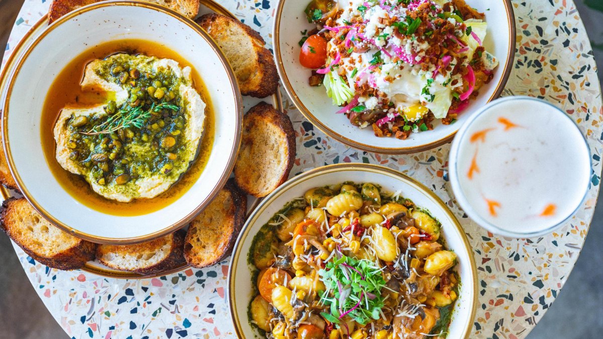 Three vegan dishes on a speckled table