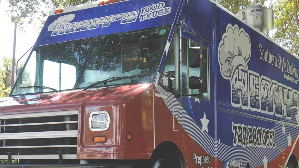 Close-up of a food truck with "Heavy's Food Truck" over the windshield