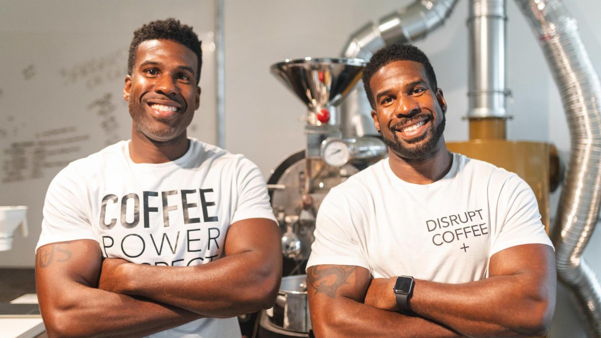 Twin black men wearing white T-shirts with coffee slogans