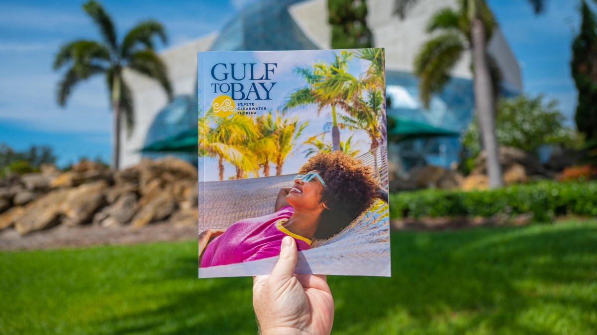 Copy of Gulf to Bay magazine held up in front of Dali Museum