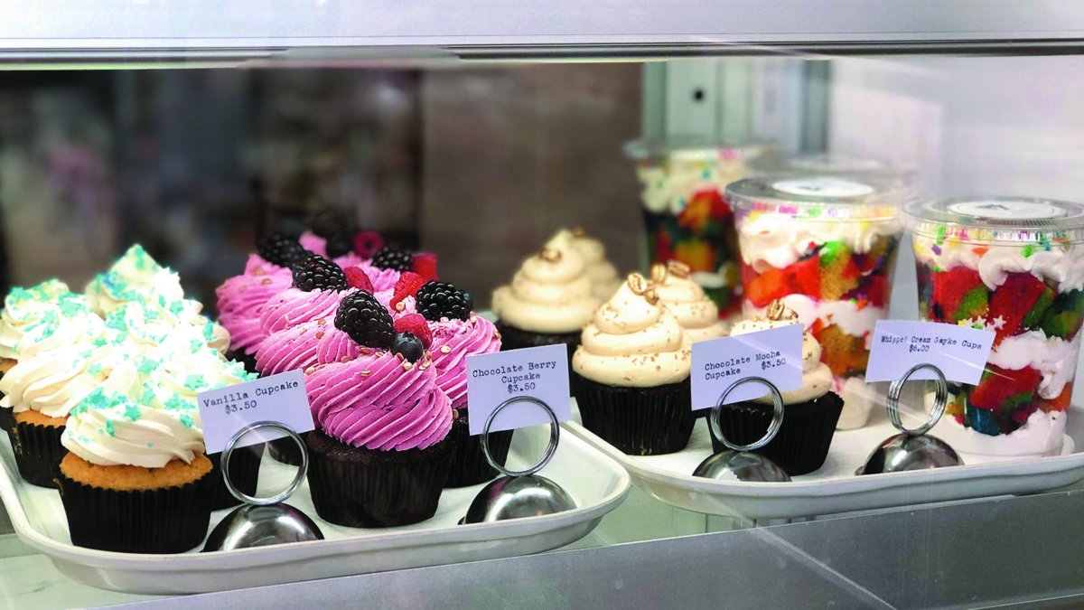 Cupcakes and other desserts in a cooler case.