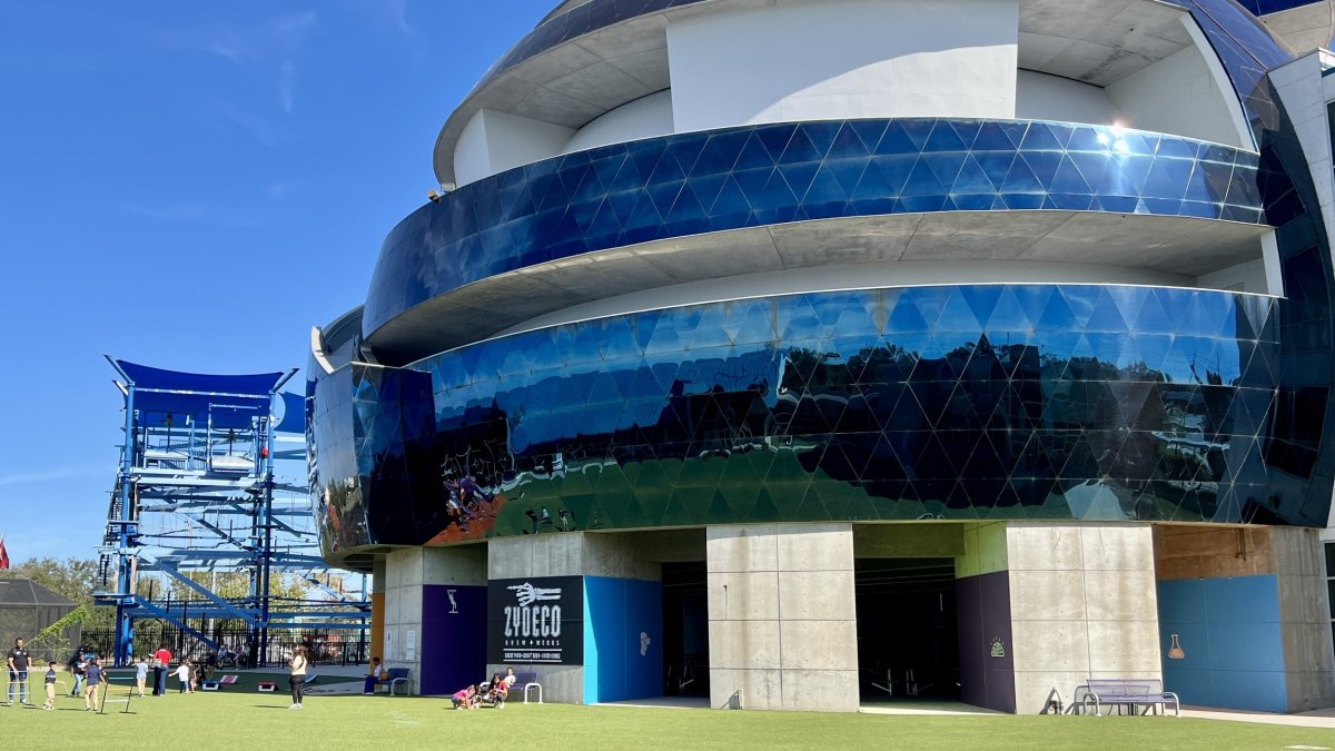 Exterior view of blue dome at MOSI featuring a round dome with blue windows and grassy area surrounding the dome.